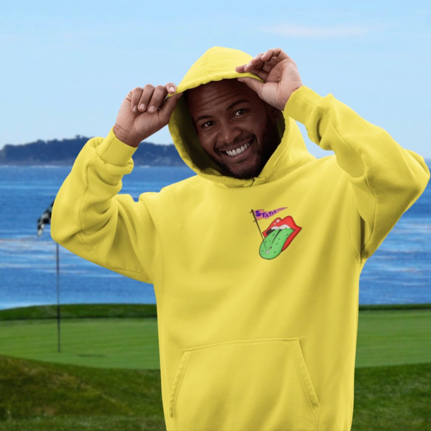man wearing golf lips hoodie near water on a golf course