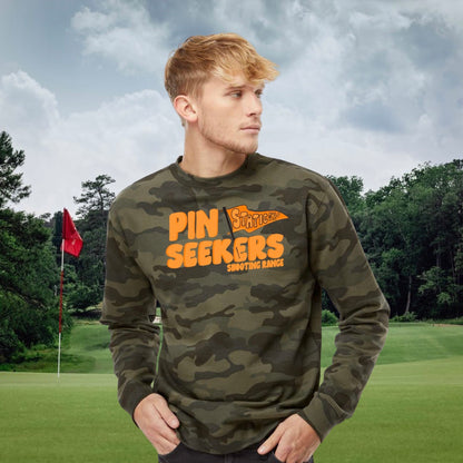 man wearing pin seekers camo golf sweatshirt standing on a golf course. 